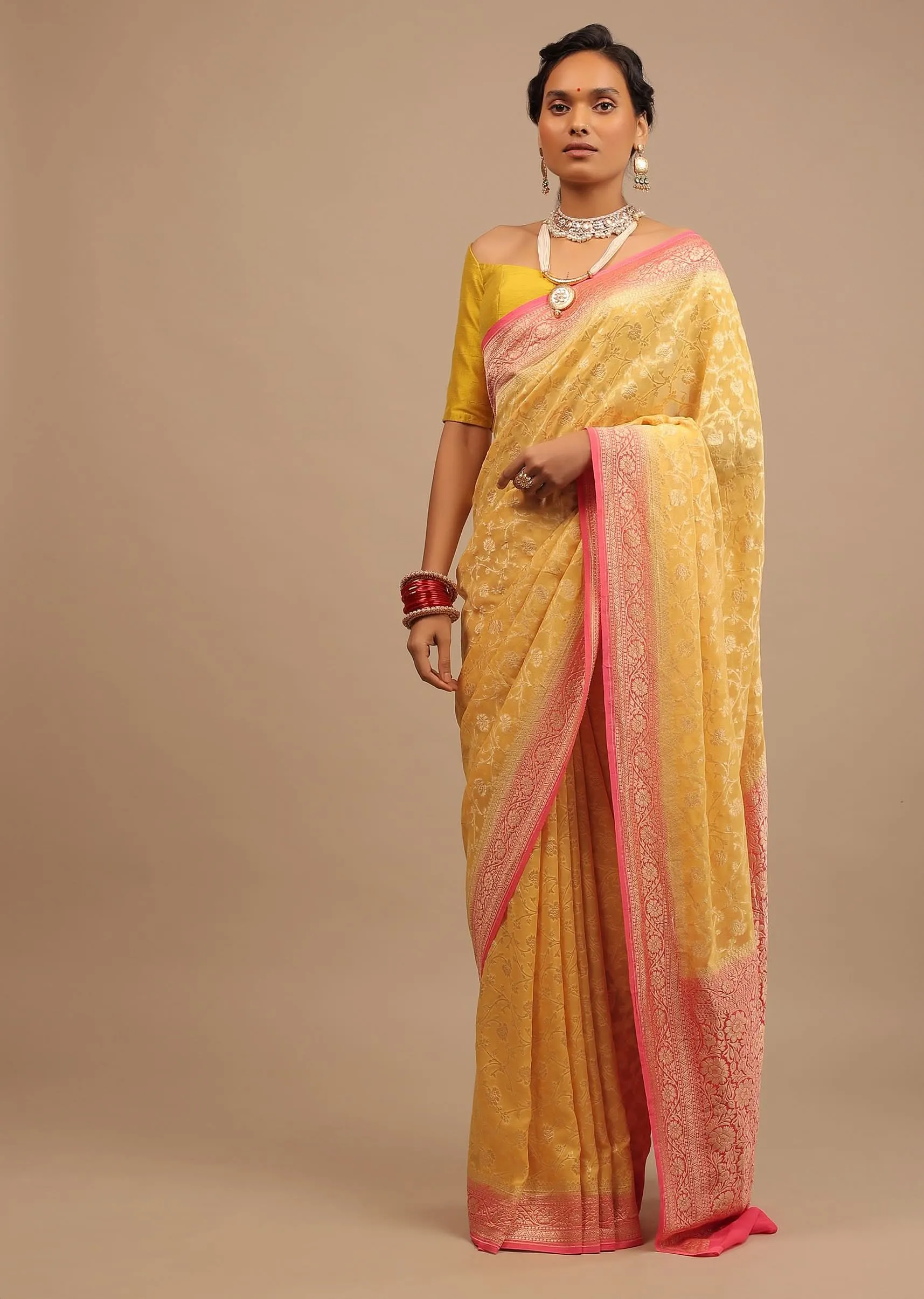 Canary Yellow Traditional Georgette Saree With Contrasting Peach Brocade Border And Jaal Work